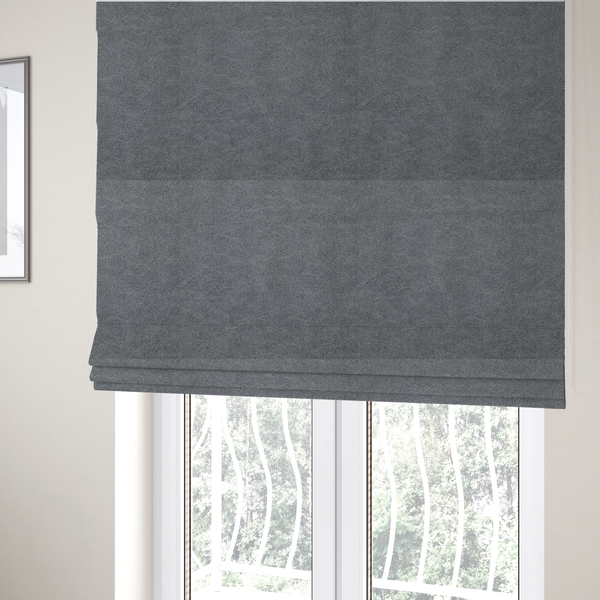 The fabric used to create these Roman blinds is a charcoal or slate grey fabric with a rich, distressed felt-like texture. The surface features an intricate, stippled pattern of deep grey fibres mixed with lighter silver highlights. It is characterized by organic, vein-like distressing and light-coloured crackle lines, mimicking the look of weathered leather or heavy-duty industrial felt.