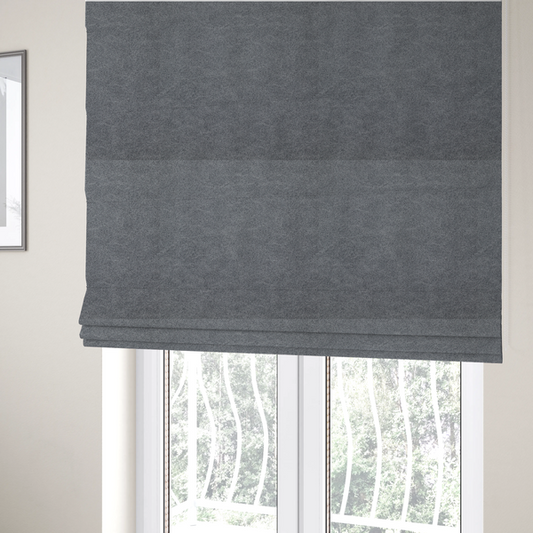 The fabric used to create these Roman blinds is a charcoal or slate grey fabric with a rich, distressed felt-like texture. The surface features an intricate, stippled pattern of deep grey fibres mixed with lighter silver highlights. It is characterized by organic, vein-like distressing and light-coloured crackle lines, mimicking the look of weathered leather or heavy-duty industrial felt.