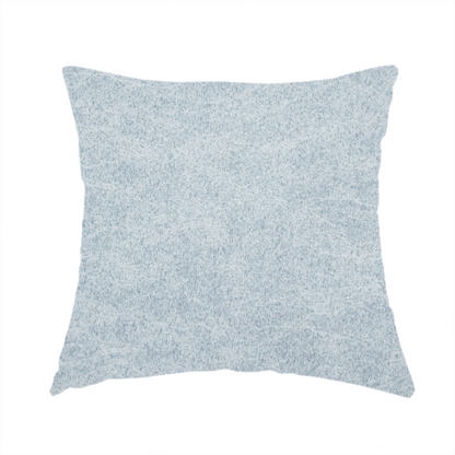 The fabric used to create this handmade cushion is a light sky blue or powder blue fabric with a dense, distressed felt-like texture. The surface features a soft, mottled blend of pale blue and white fibres, creating a subtle weathered effect. It includes the signature irregular, light-coloured "crackle" lines seen throughout this collection, giving it the appearance of weathered microfiber or industrial wool.