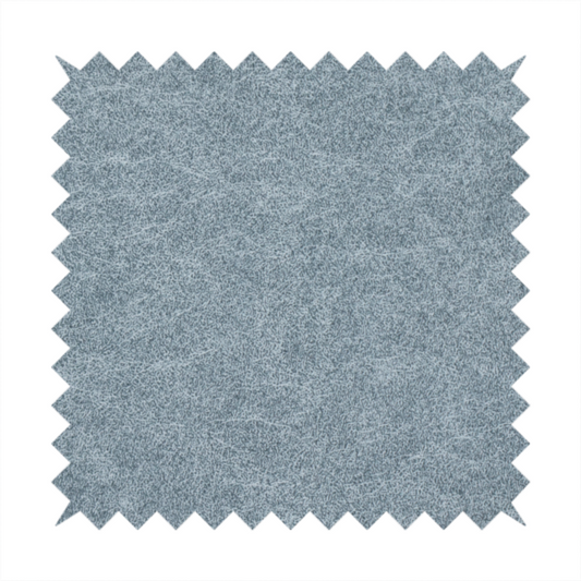 A steel blue or denim grey fabric with a dense, distressed felt-like texture. The material features a sophisticated mottled blend of medium blue and grey fibres, creating a cool-toned weathered effect. It includes the collection’s signature irregular, light-coloured "crackle" lines that give it the weathered appearance of premium distressed suede or industrial wool.