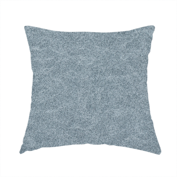 The fabric used to create this handmade cushion is a steel blue or denim grey fabric with a dense, distressed felt-like texture. The material features a sophisticated mottled blend of medium blue and grey fibres, creating a cool-toned weathered effect. It includes the collection’s signature irregular, light-coloured "crackle" lines that give it the weathered appearance of premium distressed suede or industrial wool.