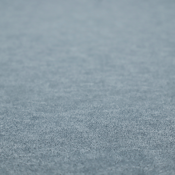 A steel blue or denim grey fabric with a dense, distressed felt-like texture. The material features a sophisticated mottled blend of medium blue and grey fibres, creating a cool-toned weathered effect. It includes the collection’s signature irregular, light-coloured "crackle" lines that give it the weathered appearance of premium distressed suede or industrial wool.