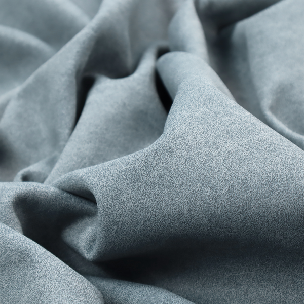 A steel blue or denim grey fabric with a dense, distressed felt-like texture. The material features a sophisticated mottled blend of medium blue and grey fibres, creating a cool-toned weathered effect. It includes the collection’s signature irregular, light-coloured "crackle" lines that give it the weathered appearance of premium distressed suede or industrial wool.