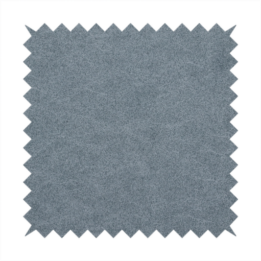 A denim or dusty blue fabric with a dense, distressed felt-like texture. The surface features an intricate mottled blend of slate blue and muted grey fibres. Like the others in this collection, it is defined by organic, light-coloured "crackle" lines and a stippled appearance that mimics the look of weathered suede or high-end industrial wool.