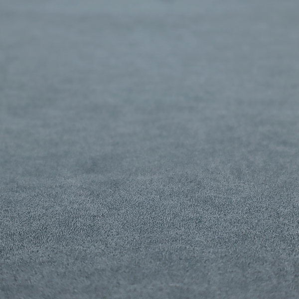 A denim or dusty blue fabric with a dense, distressed felt-like texture. The surface features an intricate mottled blend of slate blue and muted grey fibres. Like the others in this collection, it is defined by organic, light-coloured "crackle" lines and a stippled appearance that mimics the look of weathered suede or high-end industrial wool.