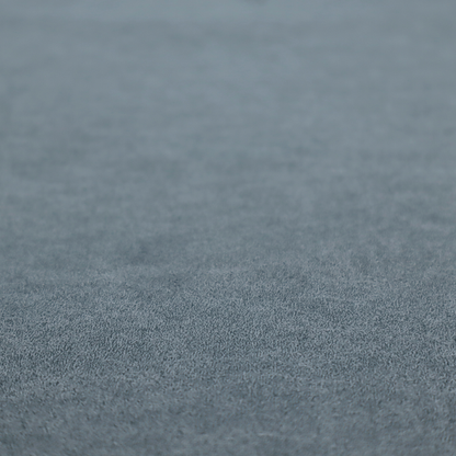 A denim or dusty blue fabric with a dense, distressed felt-like texture. The surface features an intricate mottled blend of slate blue and muted grey fibres. Like the others in this collection, it is defined by organic, light-coloured "crackle" lines and a stippled appearance that mimics the look of weathered suede or high-end industrial wool.