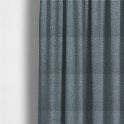 The fabric used to create these made-to-measure curtains is a denim or dusty blue fabric with a dense, distressed felt-like texture. The surface features an intricate mottled blend of slate blue and muted grey fibres. Like the others in this collection, it is defined by organic, light-coloured "crackle" lines and a stippled appearance that mimics the look of weathered suede or high-end industrial wool.