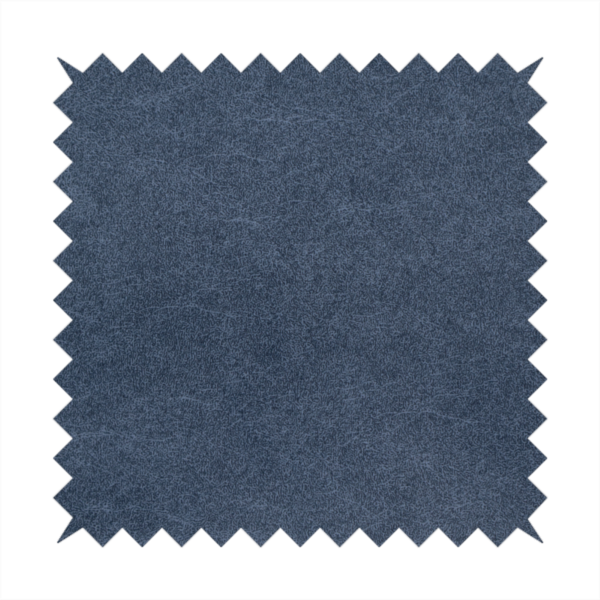 A dark slate or indigo blue fabric with a dense, distressed felt-like texture. As the deepest blue in this collection, the surface features a rich mottled blend of midnight blue and dark grey fibres. It is characterized by organic, light-coloured "crackle" lines that provide a weathered, vintage look similar to distressed leather or premium industrial wool.