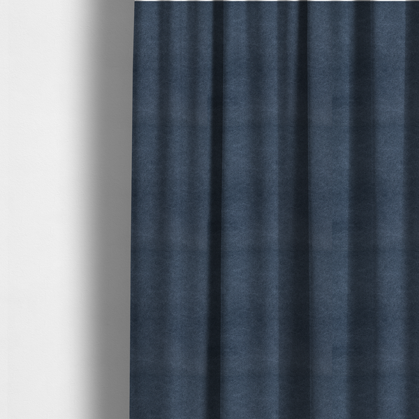 The fabric used to create these made-to-measure curtains is a dark slate or indigo blue fabric with a dense, distressed felt-like texture. As the deepest blue in this collection, the surface features a rich mottled blend of midnight blue and dark grey fibres. It is characterized by organic, light-coloured "crackle" lines that provide a weathered, vintage look similar to distressed leather or premium industrial wool.