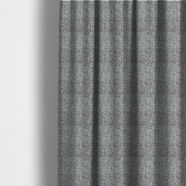 The fabric used to create these made-to-measure curtains is a dense, multi-tonal grey woven fabric. The textile features a salt-and-pepper blend of charcoal, silver-grey, and off-white yarns in a tactile, nubby bouclé weave.