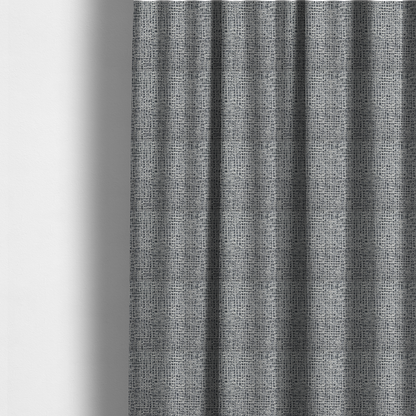 The fabric used to create these made-to-measure curtains is a dense, multi-tonal grey woven fabric. The textile features a salt-and-pepper blend of charcoal, silver-grey, and off-white yarns in a tactile, nubby bouclé weave.