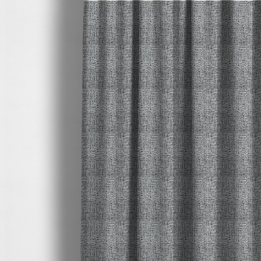The fabric used to create these made-to-measure curtains is a dense, multi-tonal grey woven fabric. The textile features a salt-and-pepper blend of charcoal, silver-grey, and off-white yarns in a tactile, nubby bouclé weave.