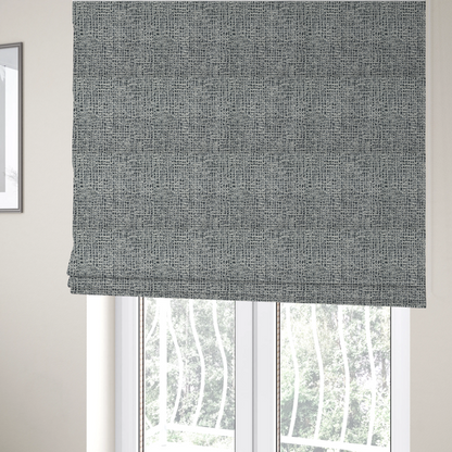 The fabric used to create these Roman blinds is a dense, multi-tonal grey woven fabric. The textile features a salt-and-pepper blend of charcoal, silver-grey, and off-white yarns in a tactile, nubby bouclé weave.