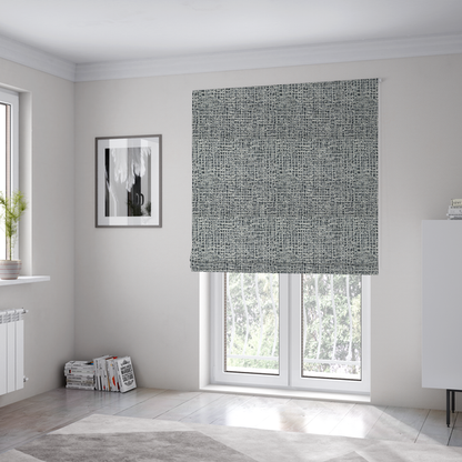The fabric used to create these Roman blinds is a dense, multi-tonal grey woven fabric. The textile features a salt-and-pepper blend of charcoal, silver-grey, and off-white yarns in a tactile, nubby bouclé weave.