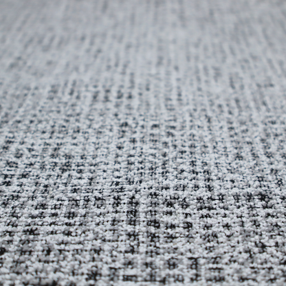 A textured woven upholstery fabric in a cool-toned grey and white salt-and-pepper pattern. The bouclé-style weave features horizontal rhythmic variations of charcoal and light grey yarns.