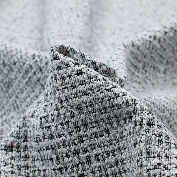 A textured woven upholstery fabric in a cool-toned grey and white salt-and-pepper pattern. The bouclé-style weave features horizontal rhythmic variations of charcoal and light grey yarns.