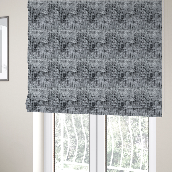 The fabric used to create these Roman blinds is a textured woven upholstery fabric in a cool-toned grey and white salt-and-pepper pattern. The bouclé-style weave features horizontal rhythmic variations of charcoal and light grey yarns.