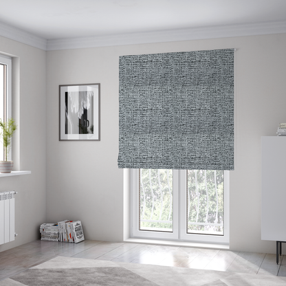 The fabric used to create these Roman blinds is a textured woven upholstery fabric in a cool-toned grey and white salt-and-pepper pattern. The bouclé-style weave features horizontal rhythmic variations of charcoal and light grey yarns.
