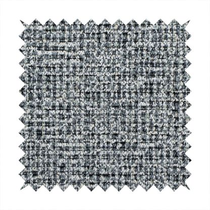 A dense, textured woven fabric in a charcoal and ash-grey salt-and-pepper pattern. The weave features tightly packed, nubby bouclé yarns with a subtle vertical and horizontal grid-like structure.