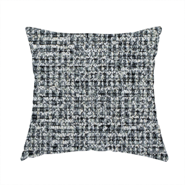 The fabric used to create this handmade cushion is a dense, textured woven fabric in a charcoal and ash-grey salt-and-pepper pattern. The weave features tightly packed, nubby bouclé yarns with a subtle vertical and horizontal grid-like structure.