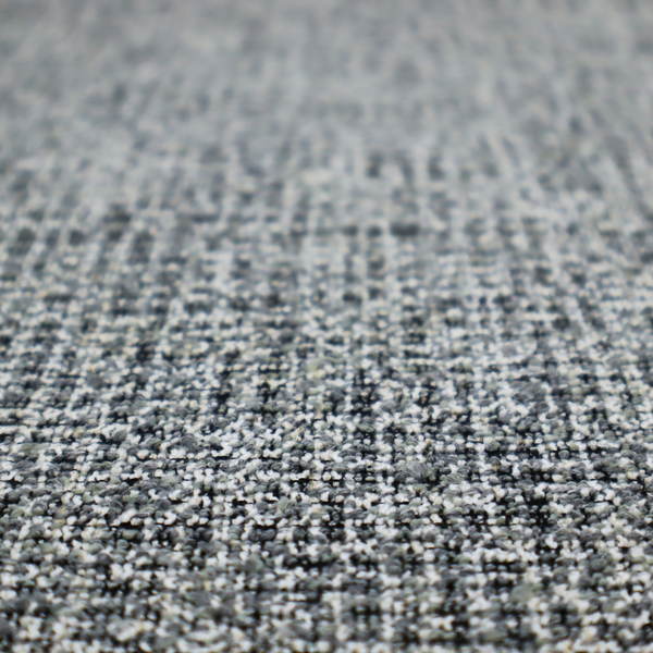 A dense, textured woven fabric in a charcoal and ash-grey salt-and-pepper pattern. The weave features tightly packed, nubby bouclé yarns with a subtle vertical and horizontal grid-like structure.