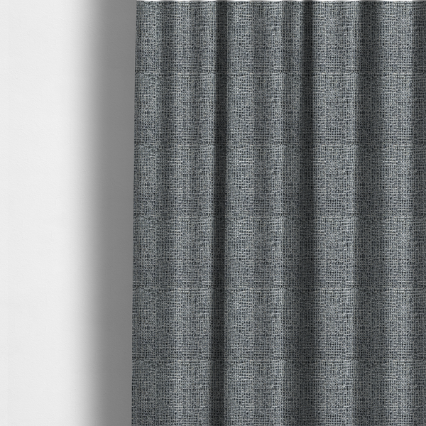 The fabric used to create these made-to-measure curtains is a dense, textured woven fabric in a charcoal and ash-grey salt-and-pepper pattern. The weave features tightly packed, nubby bouclé yarns with a subtle vertical and horizontal grid-like structure.
