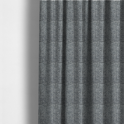 The fabric used to create these made-to-measure curtains is a dense, textured woven fabric in a charcoal and ash-grey salt-and-pepper pattern. The weave features tightly packed, nubby bouclé yarns with a subtle vertical and horizontal grid-like structure.