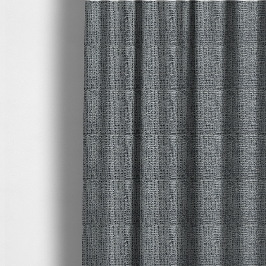 The fabric used to create these made-to-measure curtains is a dense, textured woven fabric in a charcoal and ash-grey salt-and-pepper pattern. The weave features tightly packed, nubby bouclé yarns with a subtle vertical and horizontal grid-like structure.