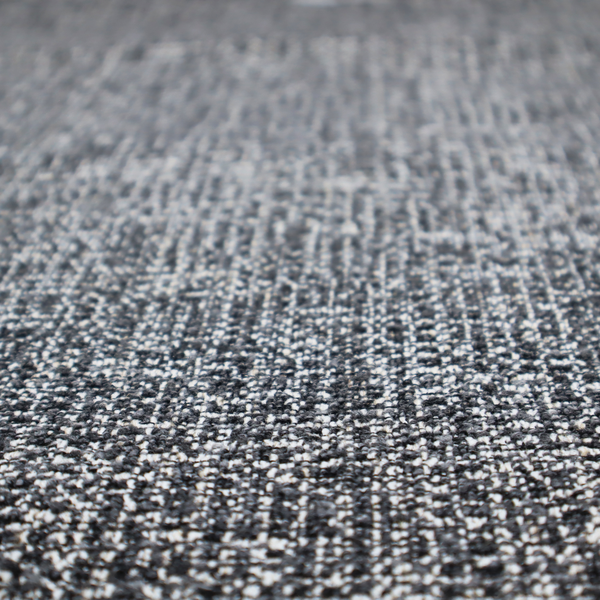 A dark, heavyweight woven fabric with a charcoal and slate-grey salt-and-pepper pattern. The dense bouclé weave creates a highly textured, pebbled surface with subtle off-white specks.