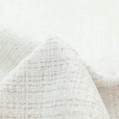 An off-white upholstery fabric. The material features a chunky, nubby boucle texture arranged in a soft horizontal and vertical grid pattern, creating a cosy and dimensional tactile surface.