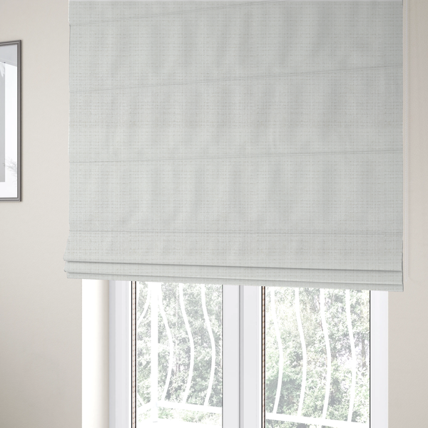 The fabric used to create these Roman blinds is a off-white upholstery fabric. The material features a chunky, nubby boucle texture arranged in a soft horizontal and vertical grid pattern, creating a cosy and dimensional tactile surface.