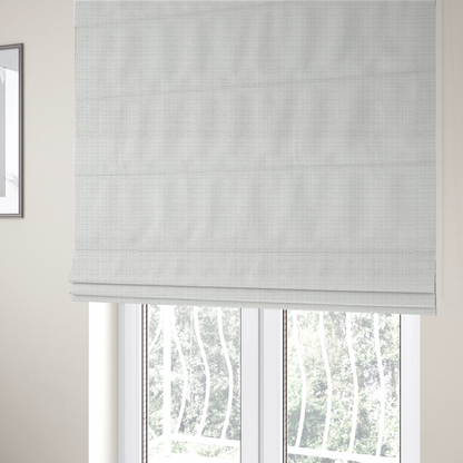 The fabric used to create these Roman blinds is a off-white upholstery fabric. The material features a chunky, nubby boucle texture arranged in a soft horizontal and vertical grid pattern, creating a cosy and dimensional tactile surface.