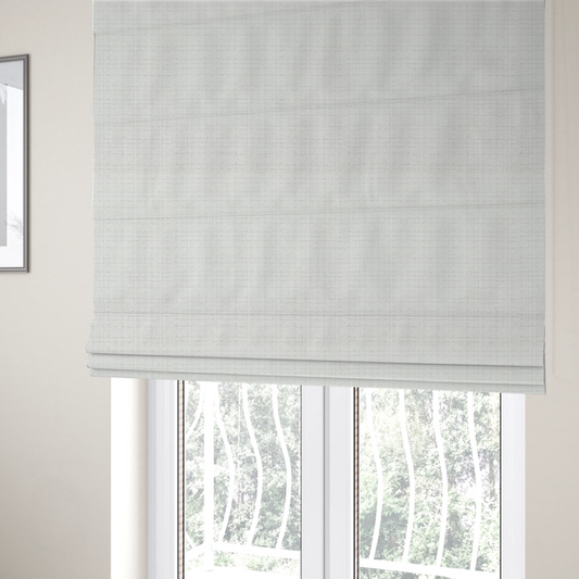 The fabric used to create these Roman blinds is a off-white upholstery fabric. The material features a chunky, nubby boucle texture arranged in a soft horizontal and vertical grid pattern, creating a cosy and dimensional tactile surface.