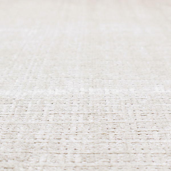 A cream and oatmeal-toned fabric. The material features a chunky, multi-tonal boucle weave with a distinct grid pattern and organic snubbed yarns, creating a dimensional and rustic look.