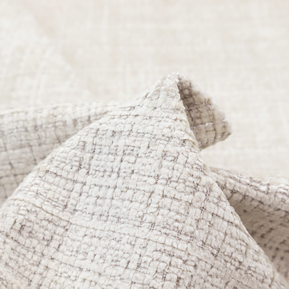 A cream and oatmeal-toned fabric. The material features a chunky, multi-tonal boucle weave with a distinct grid pattern and organic snubbed yarns, creating a dimensional and rustic look.