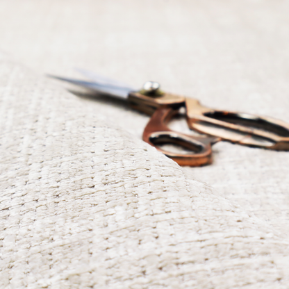 A cream and oatmeal-toned fabric. The material features a chunky, multi-tonal boucle weave with a distinct grid pattern and organic snubbed yarns, creating a dimensional and rustic look.