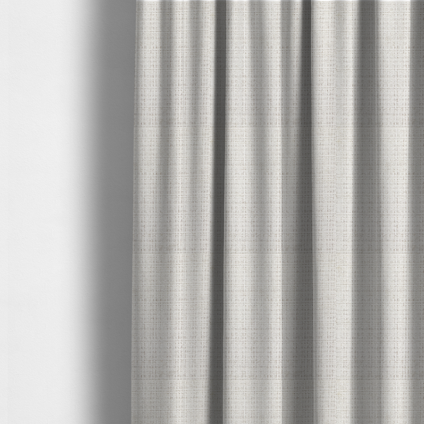 The fabric used to create these made-to-measure curtains is a cream and oatmeal-toned fabric. The material features a chunky, multi-tonal boucle weave with a distinct grid pattern and organic snubbed yarns, creating a dimensional and rustic look.