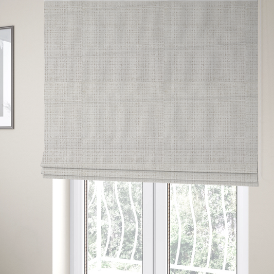 The fabric used to create these Roman blinds is a cream and oatmeal-toned fabric. The material features a chunky, multi-tonal boucle weave with a distinct grid pattern and organic snubbed yarns, creating a dimensional and rustic look.