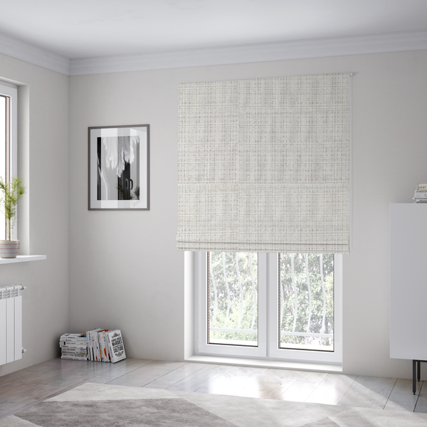 The fabric used to create these Roman blinds is a cream and oatmeal-toned fabric. The material features a chunky, multi-tonal boucle weave with a distinct grid pattern and organic snubbed yarns, creating a dimensional and rustic look.