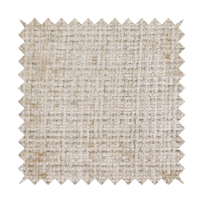 A beige and sand-toned upholstery fabric. The material features a chunky, multi-layered boucle texture with a prominent architectural grid pattern and a mix of warm tan and ivory yarns.