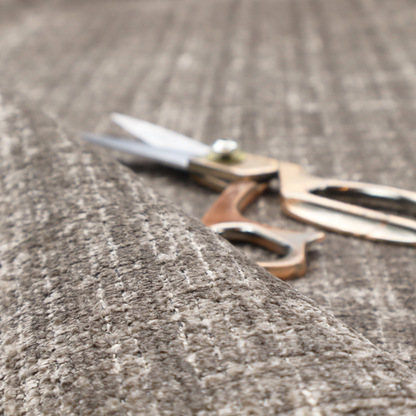 A taupe and grey textured boucle fabric with a dense, dimensional grid weave.