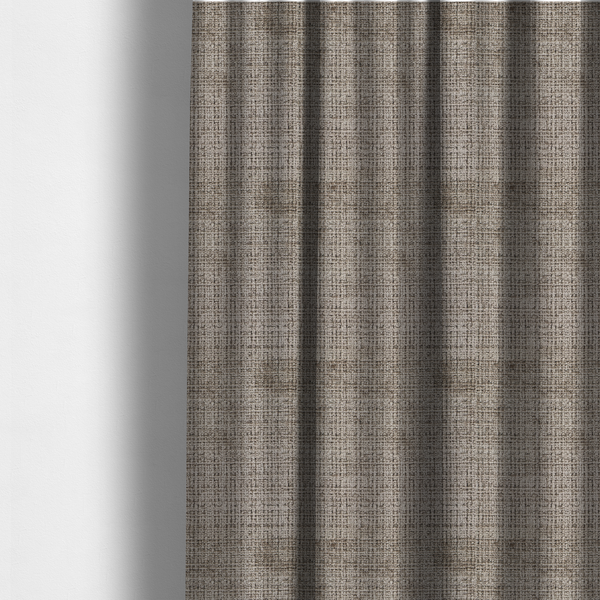 The fabric used to create these made-to-measure curtains is a taupe and grey textured boucle fabric with a dense, dimensional grid weave.