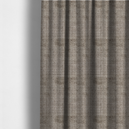 The fabric used to create these made-to-measure curtains is a taupe and grey textured boucle fabric with a dense, dimensional grid weave.