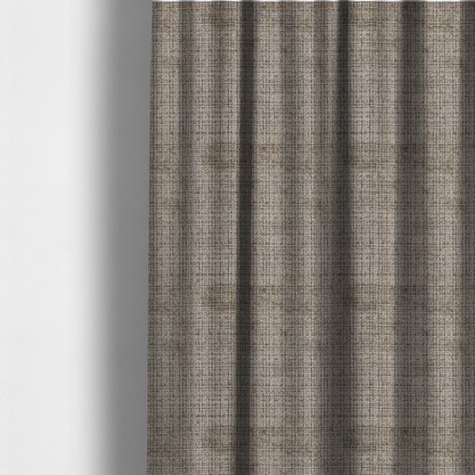 The fabric used to create these made-to-measure curtains is a taupe and grey textured boucle fabric with a dense, dimensional grid weave.