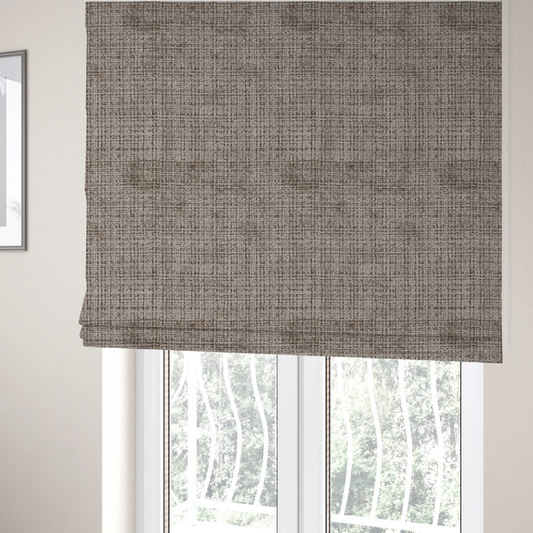 The fabric used to create these Roman blinds is a taupe and grey textured boucle fabric with a dense, dimensional grid weave.