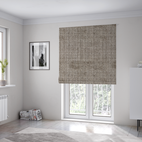 The fabric used to create these Roman blinds is a taupe and grey textured boucle fabric with a dense, dimensional grid weave.