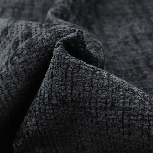 A dark charcoal upholstery fabric. The material features a heavy boucle texture with a prominent, recessed grid pattern, creating a rich, tactile surface with deep shadows and sophisticated dark grey tones.