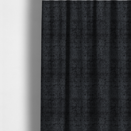 The fabric used to create these made-to-measure curtains is a dark charcoal upholstery fabric. The material features a heavy boucle texture with a prominent, recessed grid pattern, creating a rich, tactile surface with deep shadows and sophisticated dark grey tones.