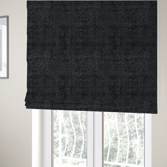 The fabric used to create these Roman blinds is a dark charcoal upholstery fabric. The material features a heavy boucle texture with a prominent, recessed grid pattern, creating a rich, tactile surface with deep shadows and sophisticated dark grey tones.