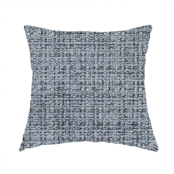 The fabric used to create these handmade cushions is a slate blue and grey textured boucle fabric with a dense, dimensional grid weave.